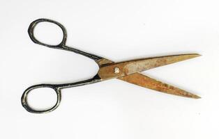 Rustic, vintage scissors isolated on white. A timeless tool, symbolizing cutting ties, making choices, or the passage of time. Ideal for concepts of nostalgia, craftsmanship, or DIY projects. photo