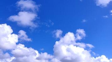 Stunning vibrant blue sky canvas adorned with fluffy white cumulus clouds. Perfect for backgrounds, websites, or illustrating concepts of freedom, serenity, and weather. photo