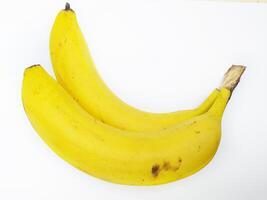 Two ripe yellow bananas nestled together against a stark white background. photo