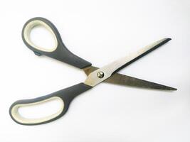 Closeup of simple, everyday scissors on a white background. A clean, minimalist image suggesting concepts of cutting, precision, and new beginnings. photo