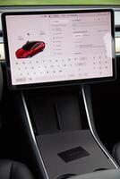 Vilnius, Lithuania, 2024 - View inside of Tesla Model 3, huge dispay and car key photo