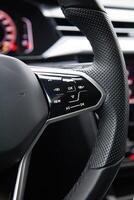 Buttons on the modern multifunctional steering wheel for controlling music and multimedia photo