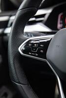 Buttons on the modern multifunctional steering wheel for controlling cruise control, lane keeping and distronic photo