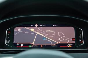 Dashboard screen with navigation on the car control panel, speedometer, fuel and engine temperature level photo