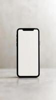Blank smartphone standing on a modern table against a neutral background, showcasing minimalist design and elegance photo