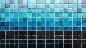 Cyan mosaic tiles overlay blue and black shades in a contemporary setting captured from an artistic perspective photo