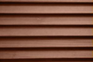 Color of the year 2025 Mocha Mousse. Old grunge dark textured wooden background with holes. The surface of the brown texture of wooden blinds photo