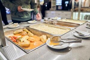 Getting hot food for the poor from volunteers. The concept of nutrition in a charity canteen. with space to copy photo