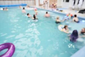 Entertainment during the holidays. An inflatable ring floating in the pool, against a background of blurred people. With space to copy photo