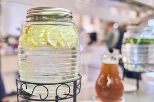 A clear pitcher of lemonade. Lemons in water. Made from a slice of lemon with a space to copy photo