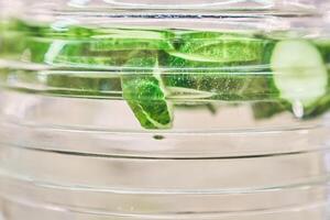 Close-up of a refreshing cucumber cocktail in a clear bottle. Transparent background with space to copy photo