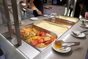 A buffet with Russian dishes, which features traditional dishes in metal containers. With space to copy photo