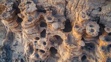An aerial view of a rock formation with holes photo