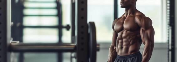 A man standing in front of a gym machine photo