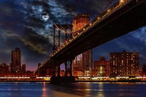Manhattan Bridge illuminated at dusk very long exposure for a perfectly smooth water photo