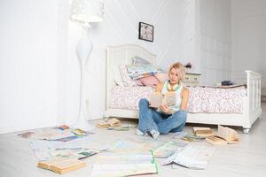 A woman sitting on the floor reading a book photo
