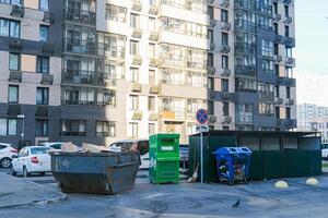 Several different containers for different types of garbage in the residential yard photo