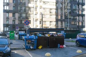 garbage containers between modern multi-storey buildings photo
