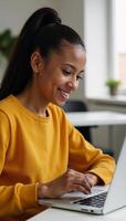 An African American college student smiling as she uses a digital tablet for elearning at her desk photo