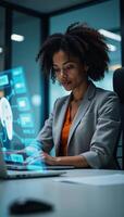 Female African American IT specialist analyzing cybersecurity threats using futuristic colorful holographic data in shades of blue and orange photo