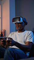elderly AfricanAmerican individual is depicted gaming via a virtual reality headset photo