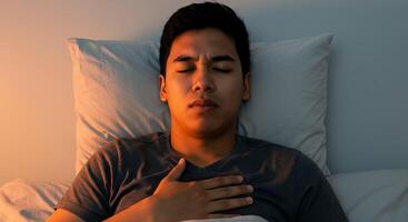 Man Lying in Bed Experiencing Chest Pain at Night photo