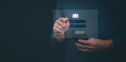 man holding smartphone with login button on dark background photo