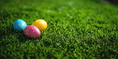 Colorful Easter eggs resting on vibrant green grass during a sunny spring afternoon photo
