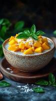 Delicious mango chia pudding topped with fresh coconut and mint leaves served in a rustic bowl on a wooden plate photo