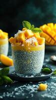 Chia pudding topped with fresh mango and coconut served on a dark background during a culinary presentation photo