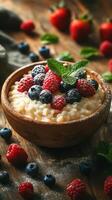 Creamy oatmeal topped with fresh berries and mint on a rustic wooden table photo