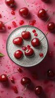 Creamy dessert with cherries and raspberry sauce on a vibrant pink surface during a sunny afternoon photo