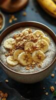 Chia seed pudding topped with banana slices and granola in a cozy kitchen setting photo