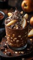 Delicious chocolate dessert with pear and whipped cream surrounded by fresh ingredients on a dark wooden table photo