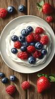Fresh berries and cream dessert served on a wooden table with vibrant colors and textures photo
