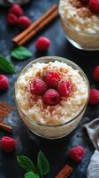 Creamy rice pudding topped with fresh raspberries and cinnamon in an elegant dessert presentation photo