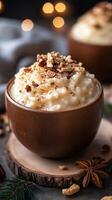 Warm dessert topped with nuts served in brown wooden bowl surrounded by cozy decorations photo