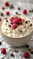 Delicious cottage cheese bowl topped with fresh raspberries and chocolate sprinkles for a healthy snack photo