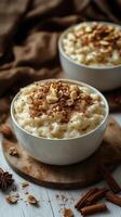 Creamy rice pudding topped with nuts and cinnamon served in elegant bowls on a rustic wooden table photo