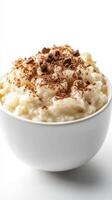 Deliciously creamy rice pudding topped with chocolate shavings served in a white bowl photo