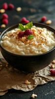Creamy rice pudding topped with fresh raspberries and nuts for a delightful dessert experience photo