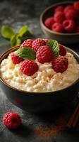 Delicious bowl of cottage cheese topped with fresh raspberries and mint leaves on a rustic table photo