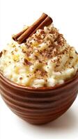 Creamy rice pudding topped with cinnamon and cocoa in a rustic bowl during a cozy winter evening photo