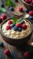 Creamy yogurt topped with fresh raspberries and blueberries on a wooden table in natural light photo