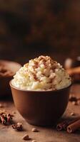 Delightful creamy dessert topped with cocoa and cinnamon served in a rustic bowl on a wooden table photo