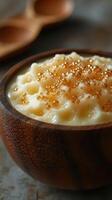 Creamy dessert topped with golden sweet pearls in a wooden bowl for a delightful culinary experience photo