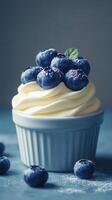Delicious blueberry dessert topped with fresh berries and cream on a blue background in a cozy setting photo