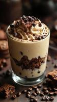 Creamy dessert with chocolate chips and coffee layered in a glass served on a wooden table photo