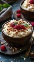 Creamy rice pudding topped with fresh raspberries and crunchy granola served in rustic bowls photo