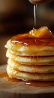 Stack of fluffy pancakes drizzled with warm syrup, ready to enjoy for breakfast or dessert photo